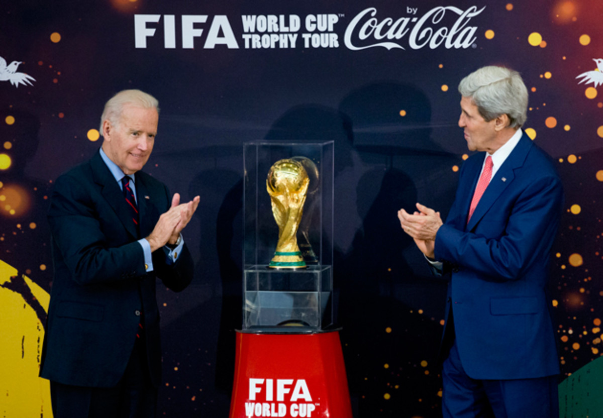 U.S. Secretary of State John Kerry, right, and Vice President Joe Biden have a look at the World Cup trophy at a U.S. State Department event in April.