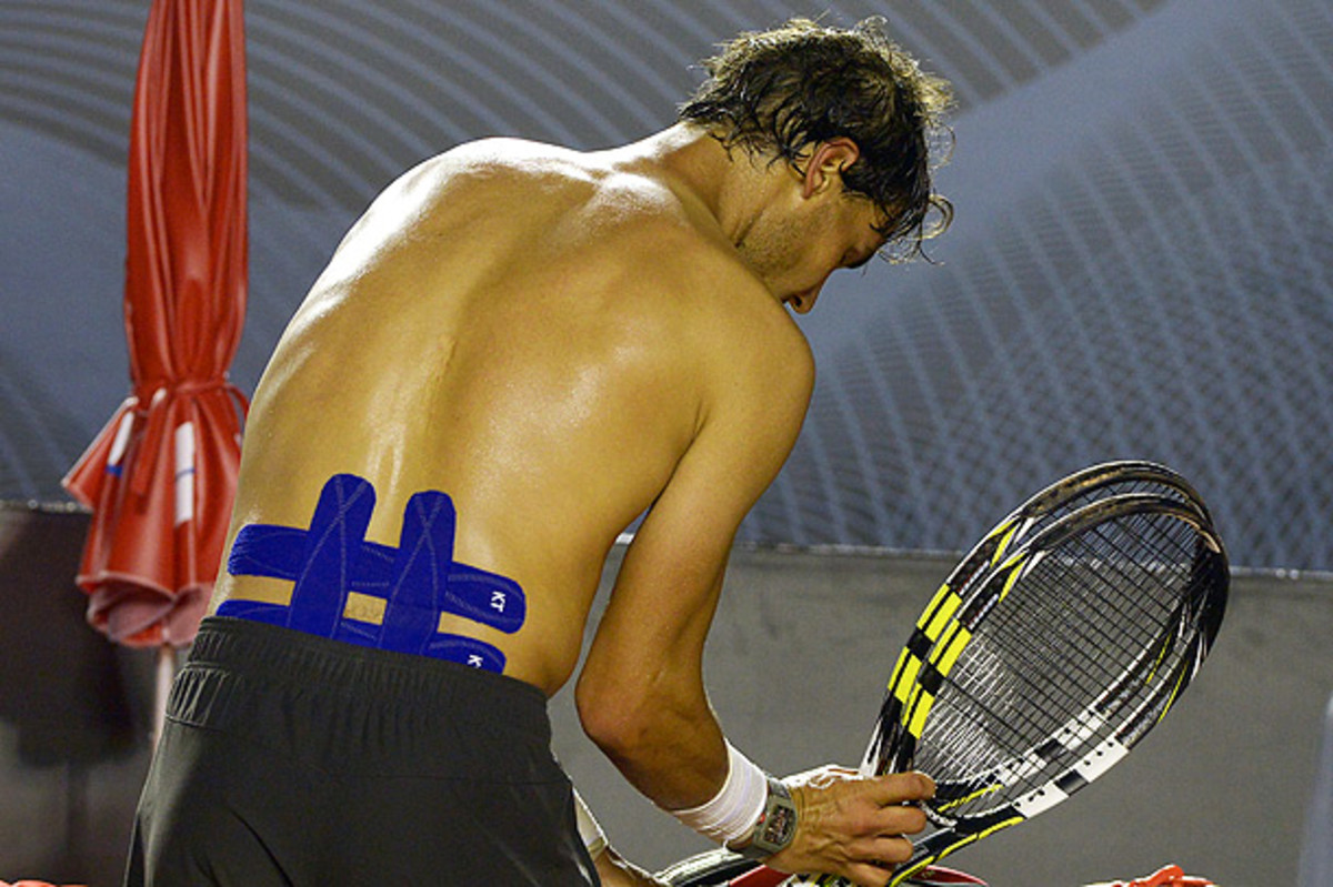 Rafael Nadal had his back taped up during the finals at (YASUYOSHI CHIBA/AFP/Getty Images)