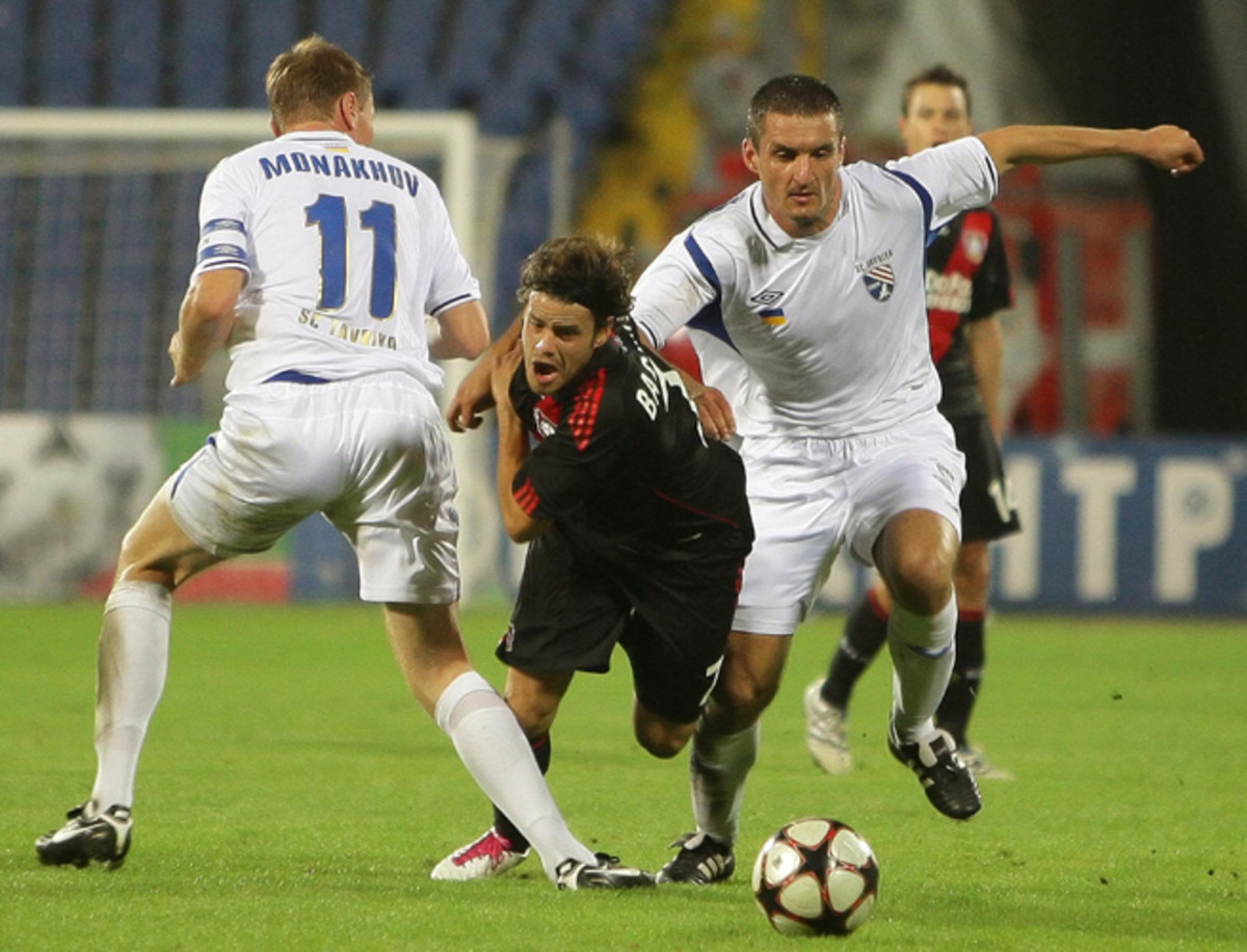 Bayer Leverkusen's Tranquillo Barnetta, center, gets tripped up by Tavriya Simferopol's Anton Monakhov during their UEFA Europa League clash in Simferopol, Ukraine, on Aug. 26, 2010. 