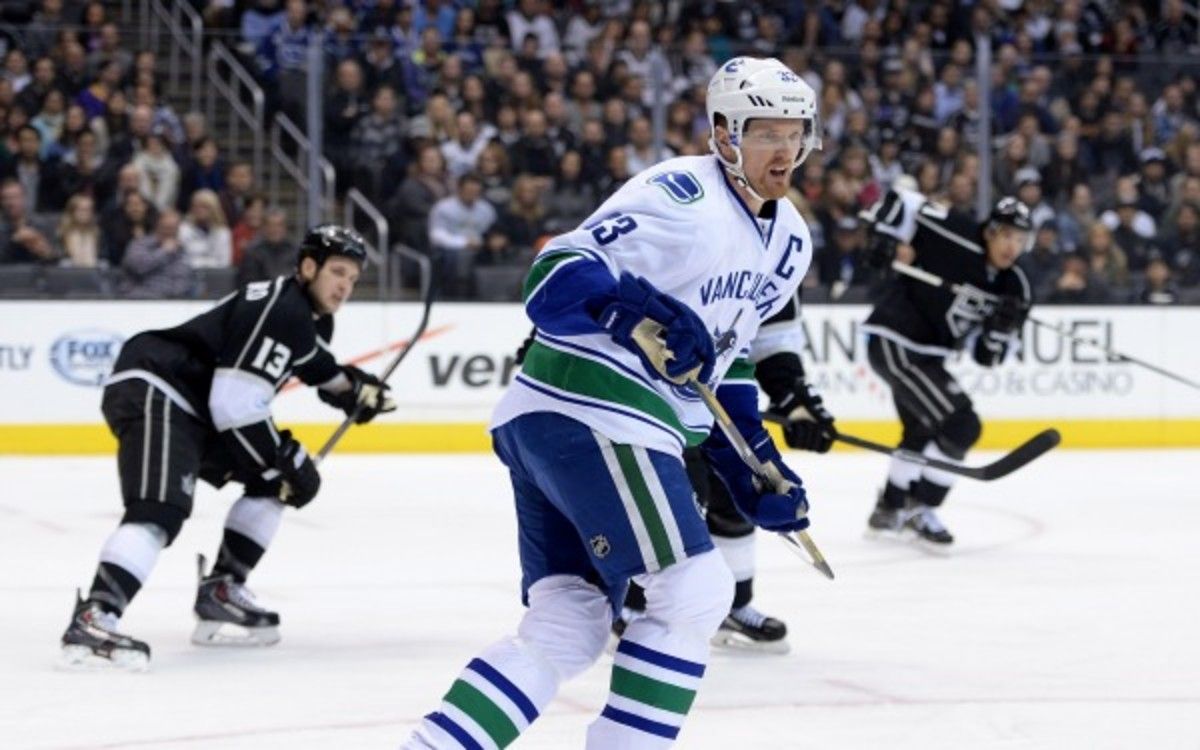 Vancouver center and captain Henrik Sedin will miss his first game in almost 10 seasons. (Harry How/Getty Images