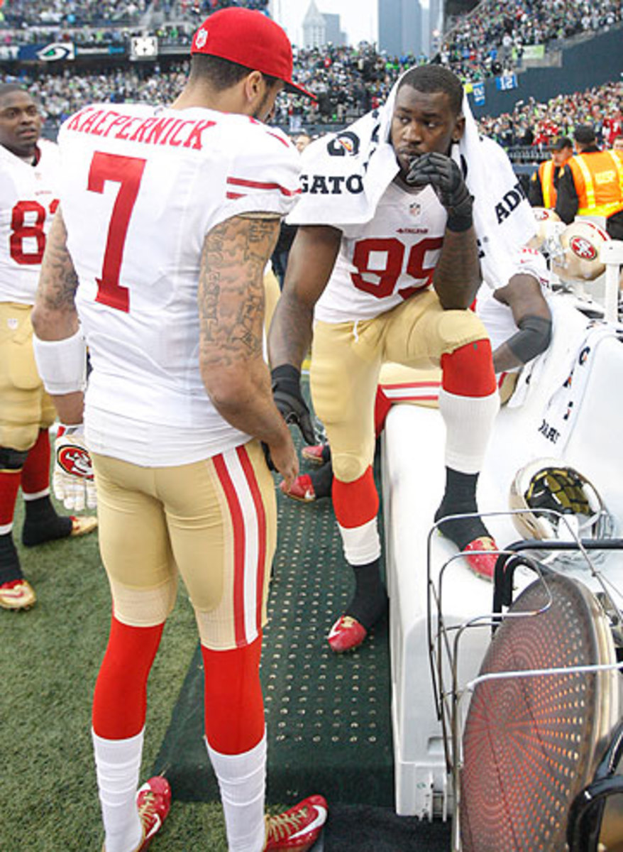 Colin Kaepernick and Aldon Smith have been in the headlines for off-field reasons this offseason. (Michael Zagaris/Getty Images)