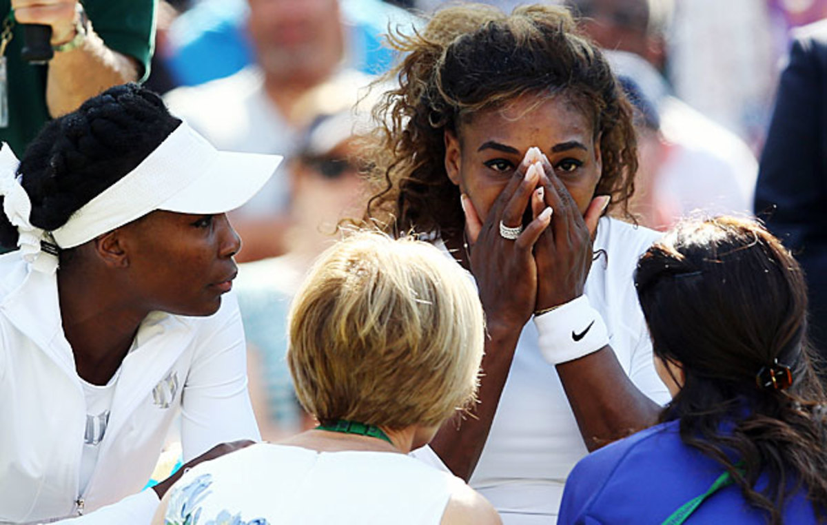 Serena Williams received attention from medical staff before retiring from a second-round doubles match.