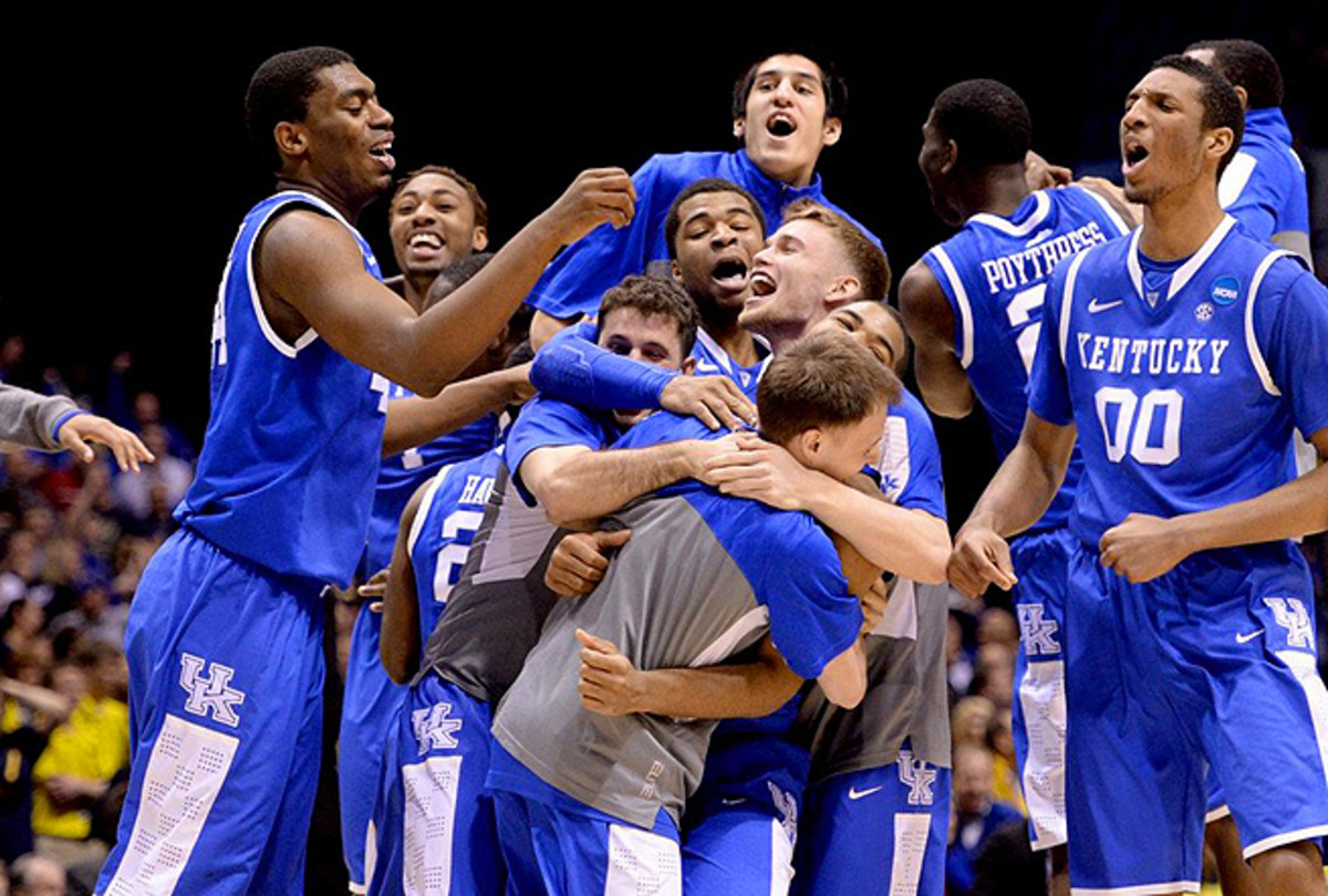 Aaron Harrison's Kentucky teammates mobbed him after he hit the game-winner against Michigan. 