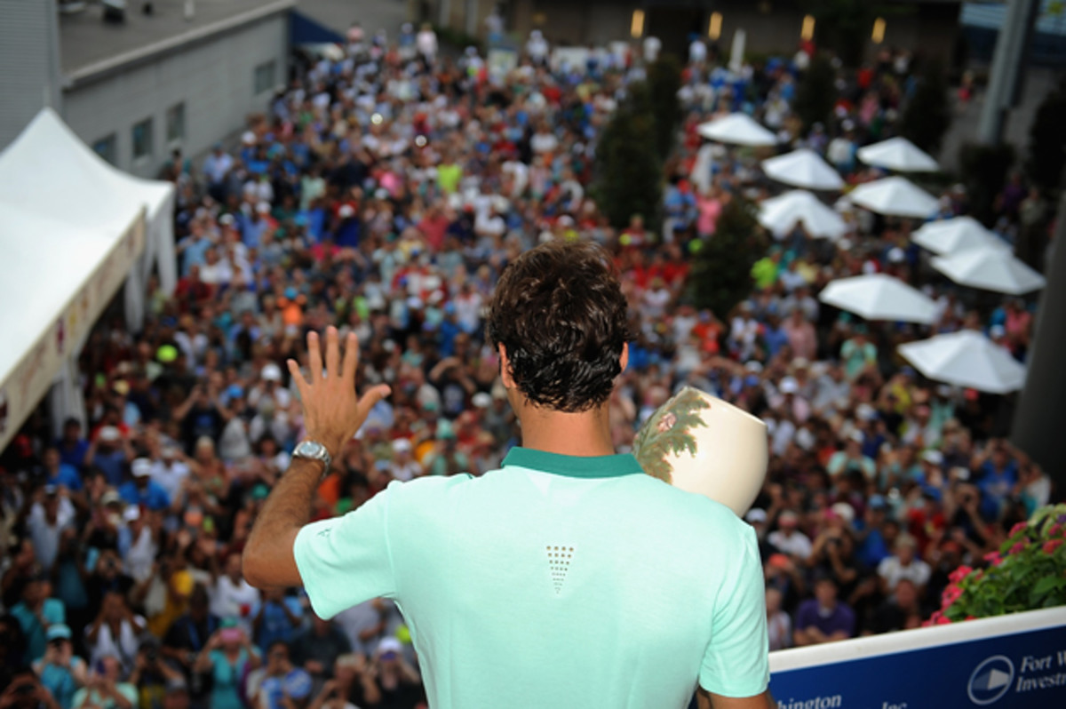 Federer poses with the winner's trophy on Champion's Balcony after his final match against David Ferrer in the Western & Southern Open.