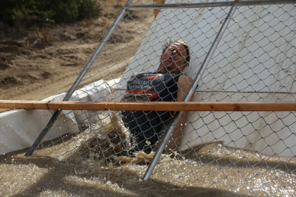 Murphy slides into icy water in a revamped version of Tough Mudder's classic obstacle, Arctic Enema.