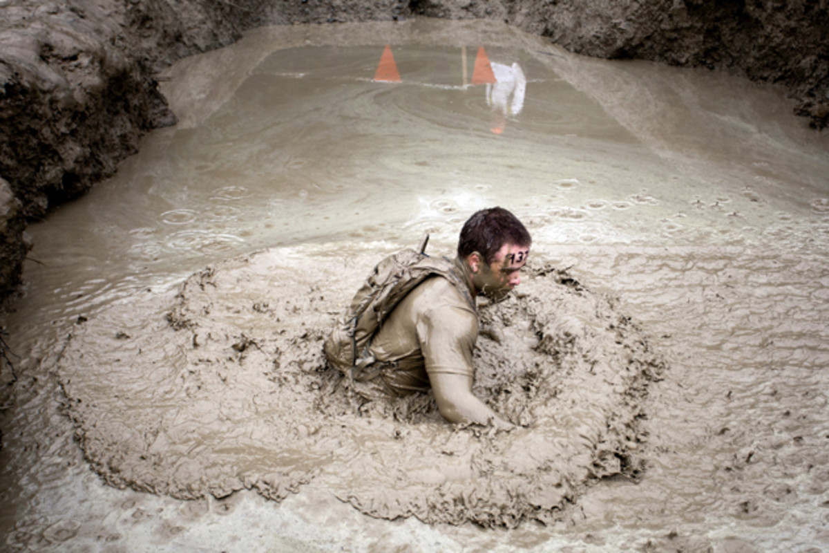 A competitor works his way through the mud mile during the Tough Mudder.