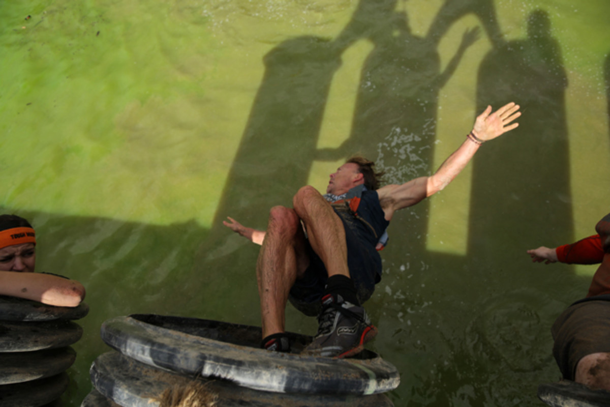 Murphy drops into water after completing Sewage Outlet obstacle during Tough Mudder's Beta Test Event.
