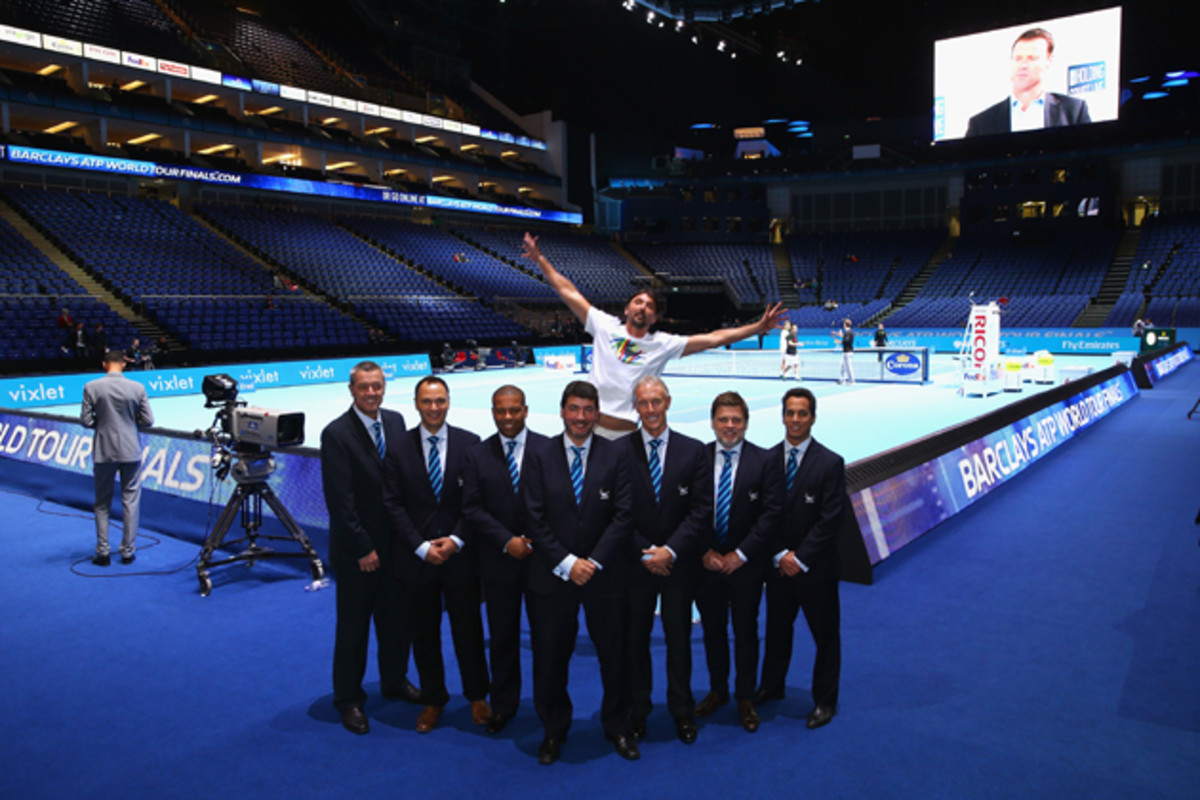 Coach of Marin Cilic, Goran Ivanisevic, jumps behind the line judges as they pose for a team photo at O2 Arena.
