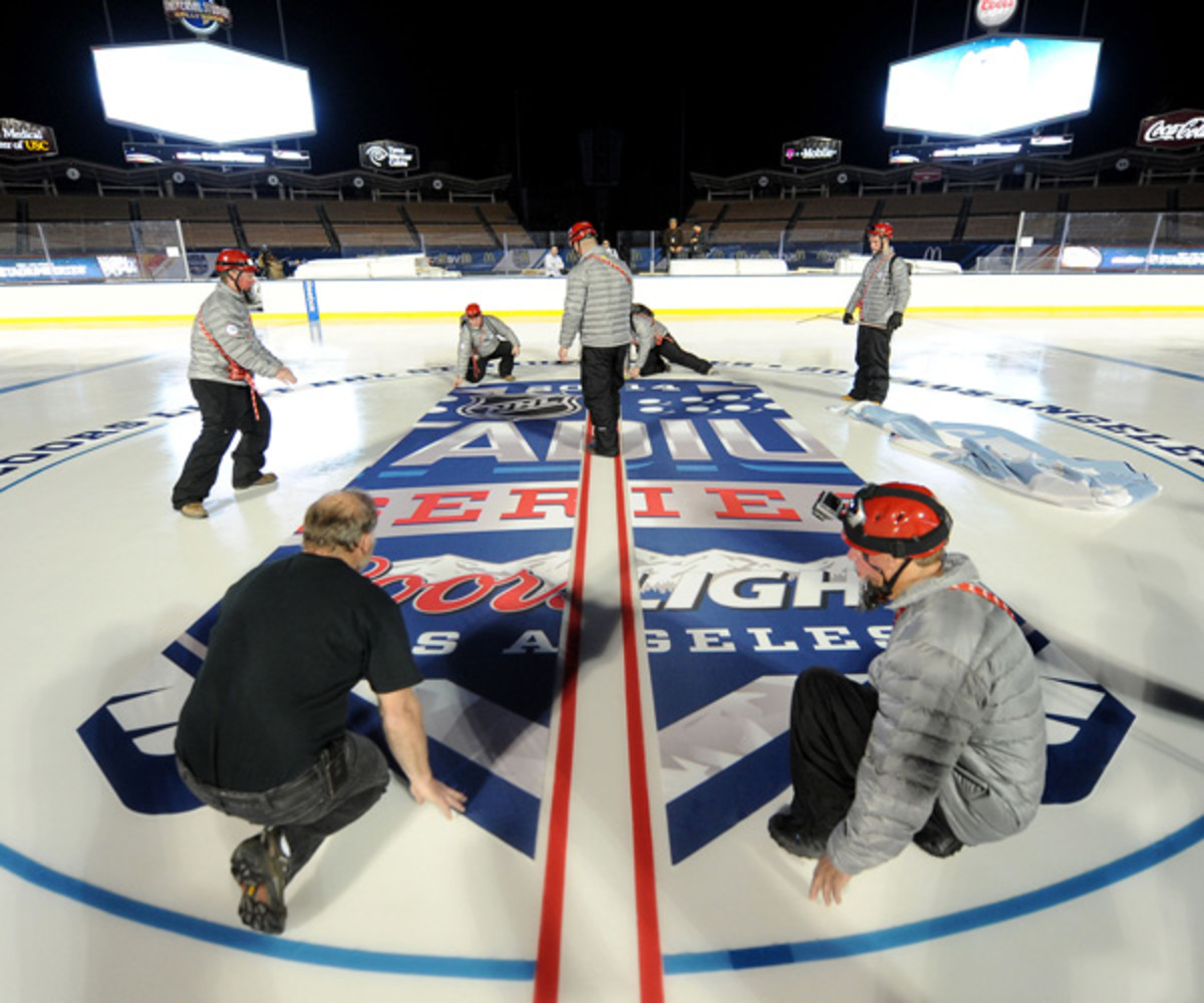 NHL Senior Director of Facilities Operations Dan Craig and members of his ice crew prepare the ice for the upcoming game between the Los Angeles Kings and the Anaheim Ducks at Dodger Stadium on January 20, 2014 in Los Angeles, California. (Photo by Noah Graham/NHLI via Getty Images)
