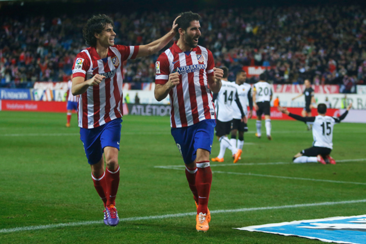 Atletico Madrid midfielder Raul Garcia, second from left, has signed an extension with the club.