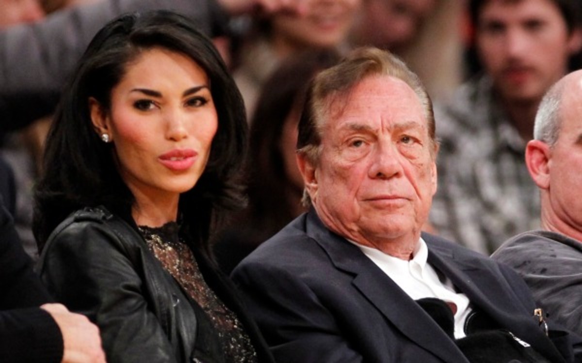 Dec. 19, 2010, file photo, Los Angeles Clippers owner Donald Sterling, third right, sits with V. Stiviano, left, as they watch the Clippers play the Los Angeles Lakers during an NBA preseason basketball game in Los Angeles. NBA commissioner Adam Silver announced Tuesday, April 29, 2014, that he is banning the owner for life from the Clippers organization over racist comments in recording. (AP Photo/Danny Moloshok, File)