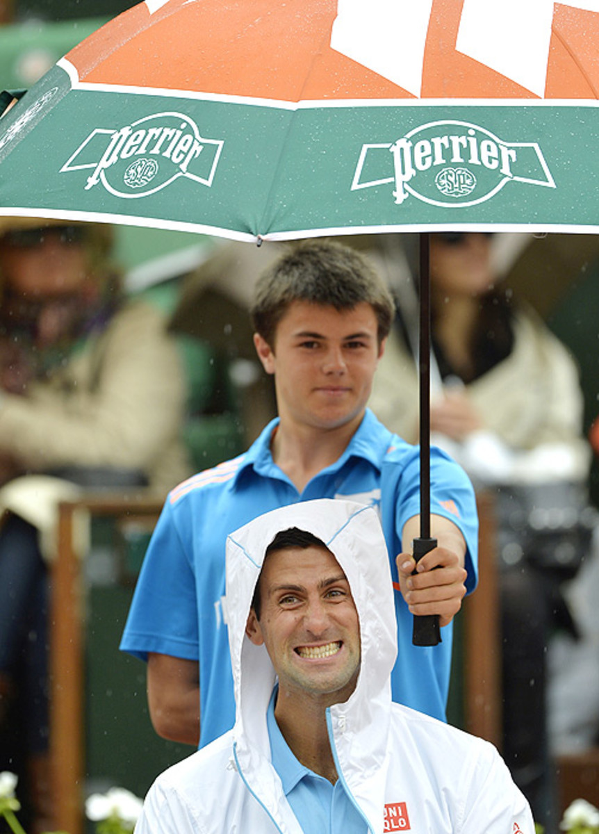 Novak Djokovic smiles for the camera during a rain delay. (MIGUEL MEDINA/AFP/Getty Images)