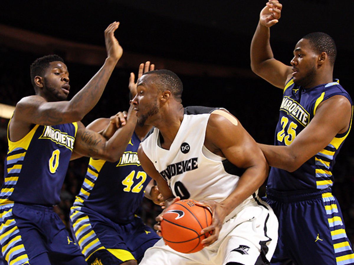 Kadeem Batts (center) and Providence survived a scare from Marquette and won in OT. (Anthony Nesmith/AP)