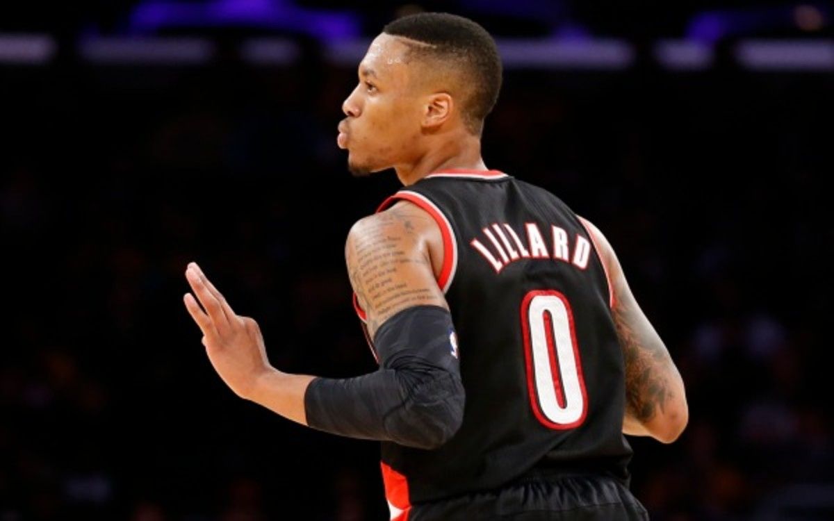 Portland Trail Blazers guard Damian Lillard reacts after making a three-pointer against the Los Angeles Lakers during the second half of an NBA basketball game in Los Angeles, Tuesday, April 1, 2014. The Trail Blazers won 124-112. (AP Photo/Danny Moloshok)