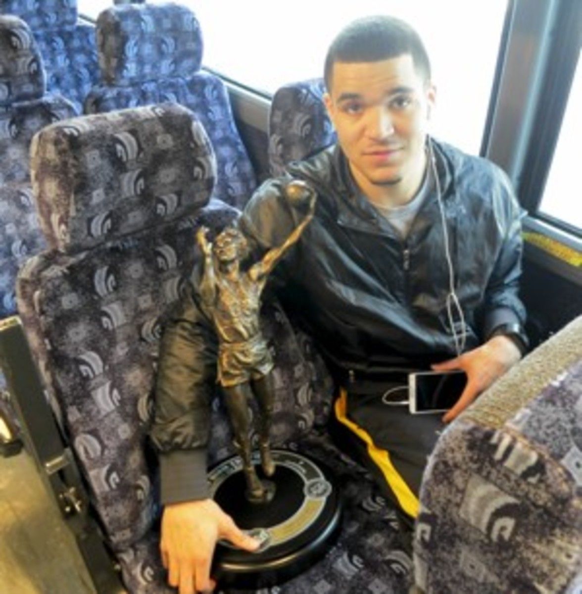Fred VanVleet holds the MVC Player of the Year award trophy en route to the Indiana State game.