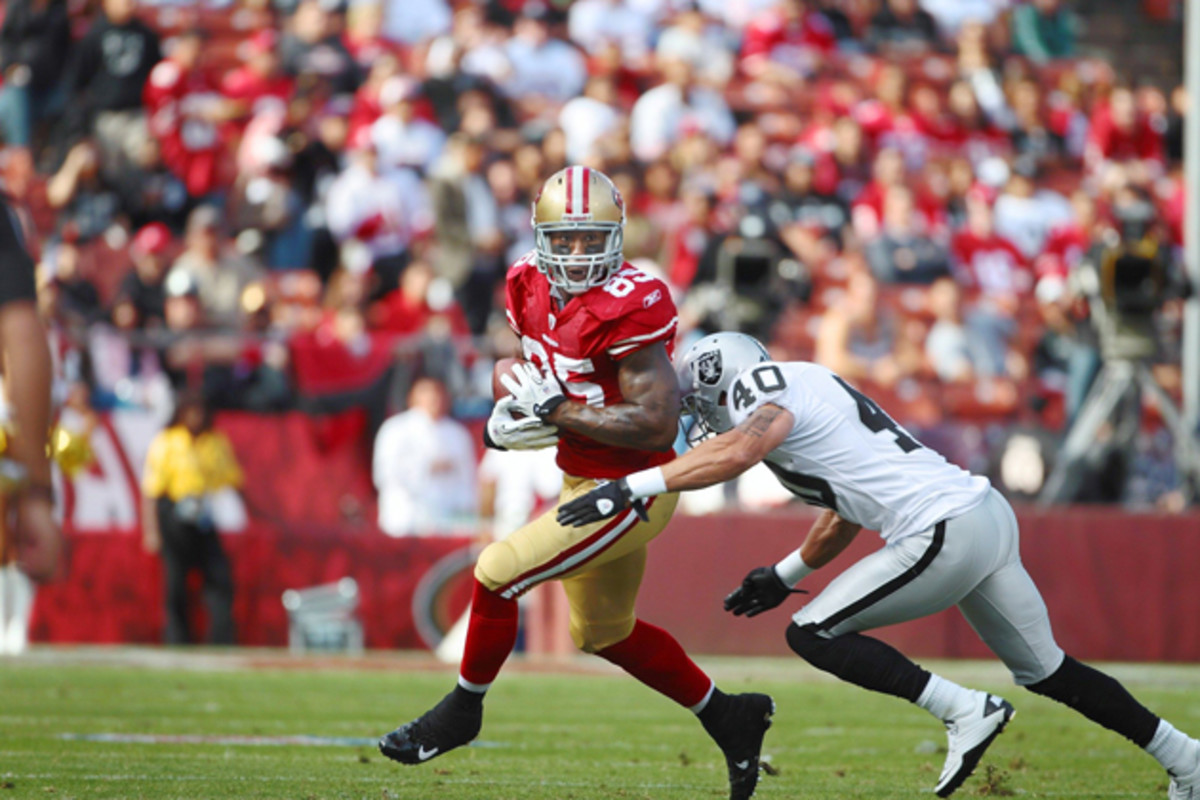 Vernon Davis uses his strength to shed tacklers and looks for running room after making a catch against the Oakland Raiders.