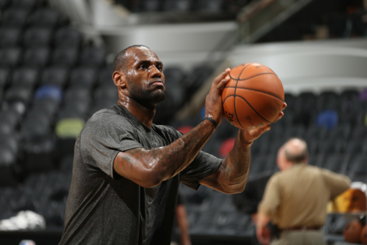LeBron James warms up during practice.