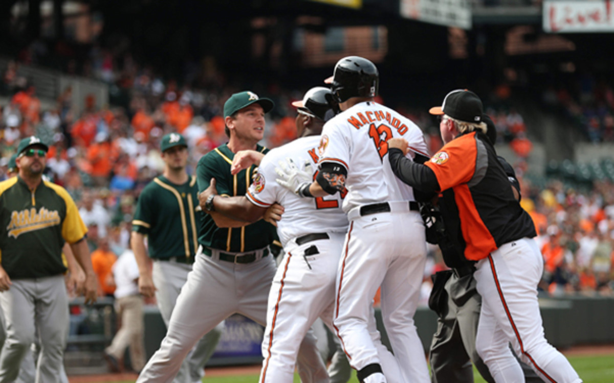 Manny Machado has to be restrained after a bench-clearing scuffle against the A's. (AP Photo/Tom DiPace)
