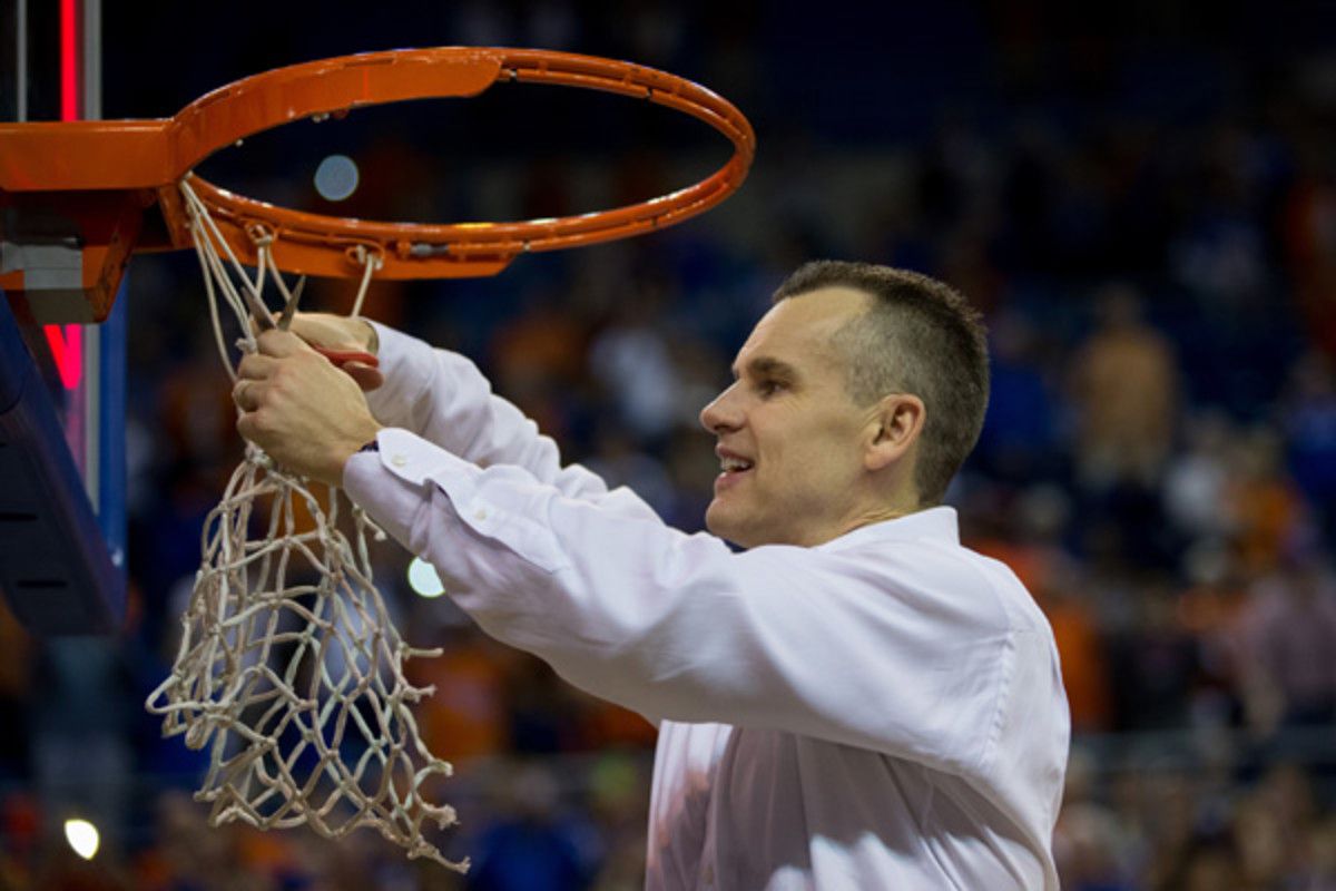 Florida coach Billy Donovan cuts the net after his team clinched an undefeated SEC season. (Rob Foldy/Getty Images)