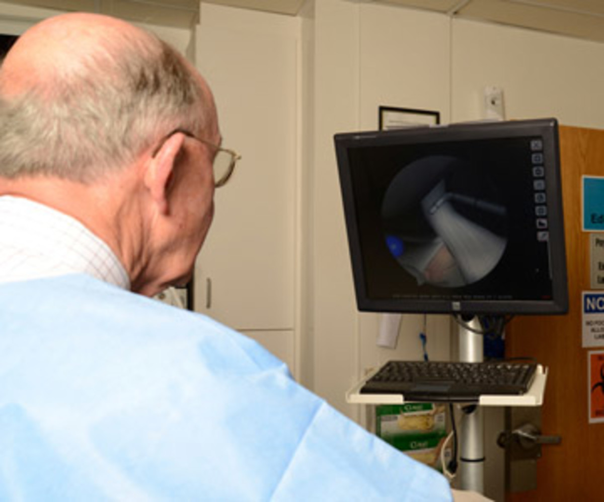 Monitors can show everyone in the operating room what the arthroscope is seeing. This surgeon is looking at the inside of an artificial knee. (Josh Merwin/Creative Culture-ID for Sports Illustrated)