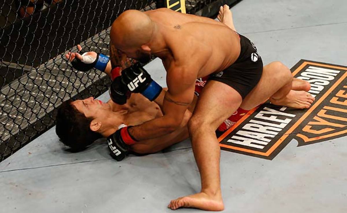 Demetrious Johnson (top) punches Joseph Benavidez in their flyweight championship bout during the UFC on FOX event at Sleep Train Arena on December 14, 2013 in Sacramento.