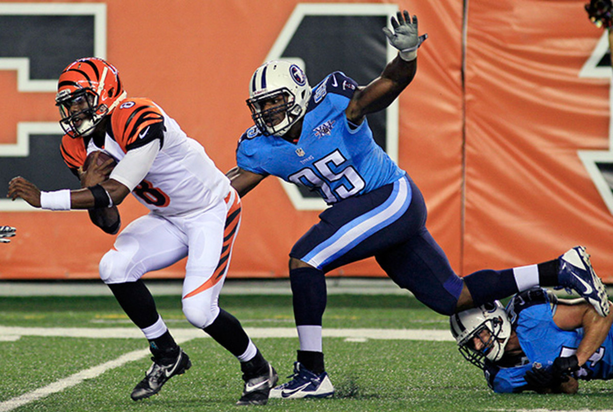 Cincinnati Bengals quarterback Josh Johnson (8) is pursued by Tennessee Titans defensive end Kamerion Wimbley (95) in the second half of a preseason game in Cincinnati, Saturday, August 2013.