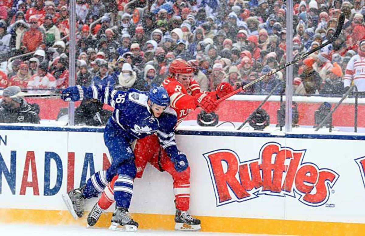  Carl Gunnarsson of the Toronto Maple Leafs hits Justin Abdelkader