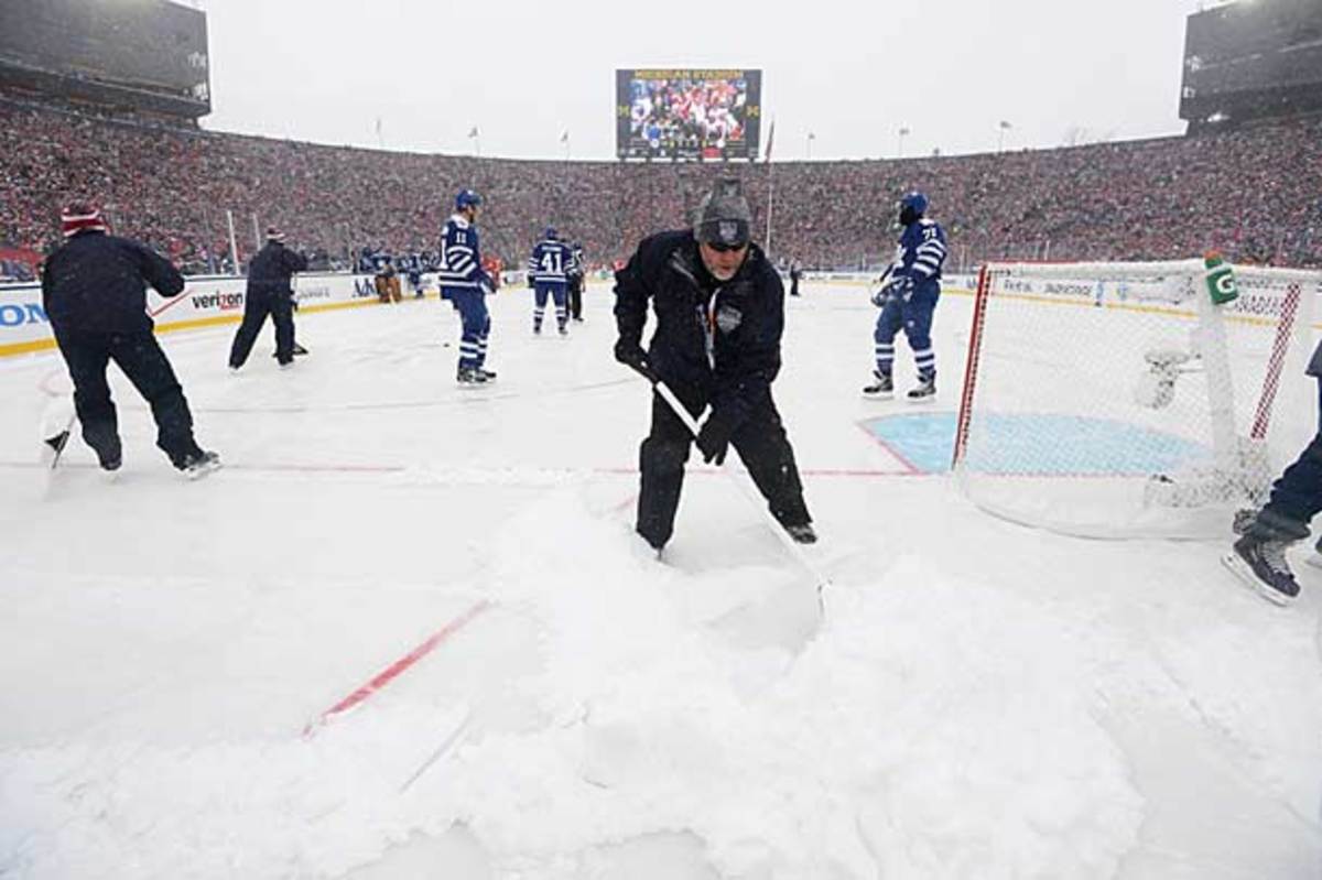 Workers remove snow from the rink at the 2014 Winter Classic.