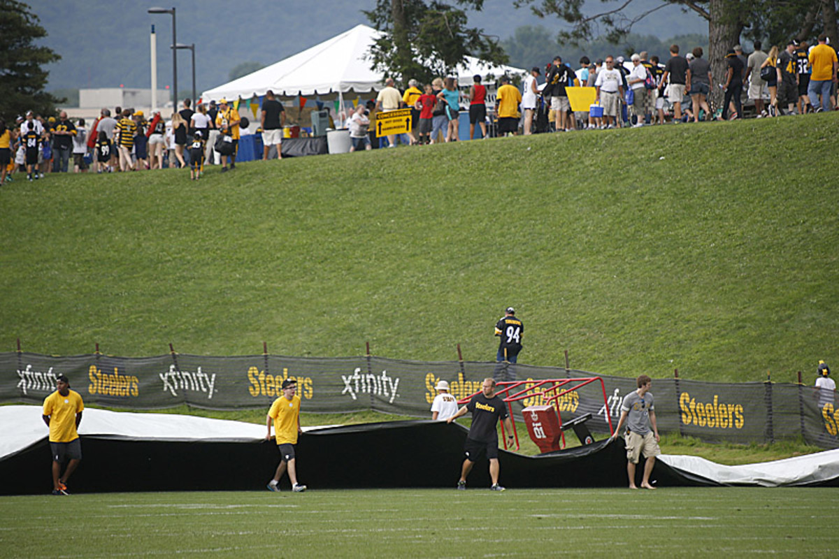 Sunday's practice was cut short when the skies opened up and the tarp came out in Latrobe. (Keith Srakocic/AP)