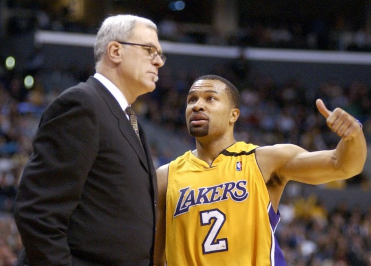 Derek Fisher (right), who won five titles playing for Phil Jackson on the Lakers, will take the weekend to think over the coaching offer. (Kirby Lee/Getty Images)