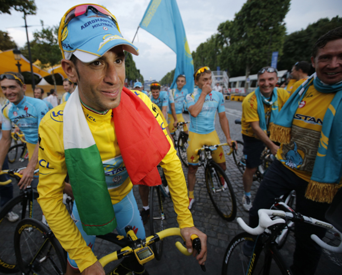 2014 Tour de France cycling race winner Italy's Vincenzo Nibali wears the Italian flag as he is about to ride in the team parade of the Tour de France.