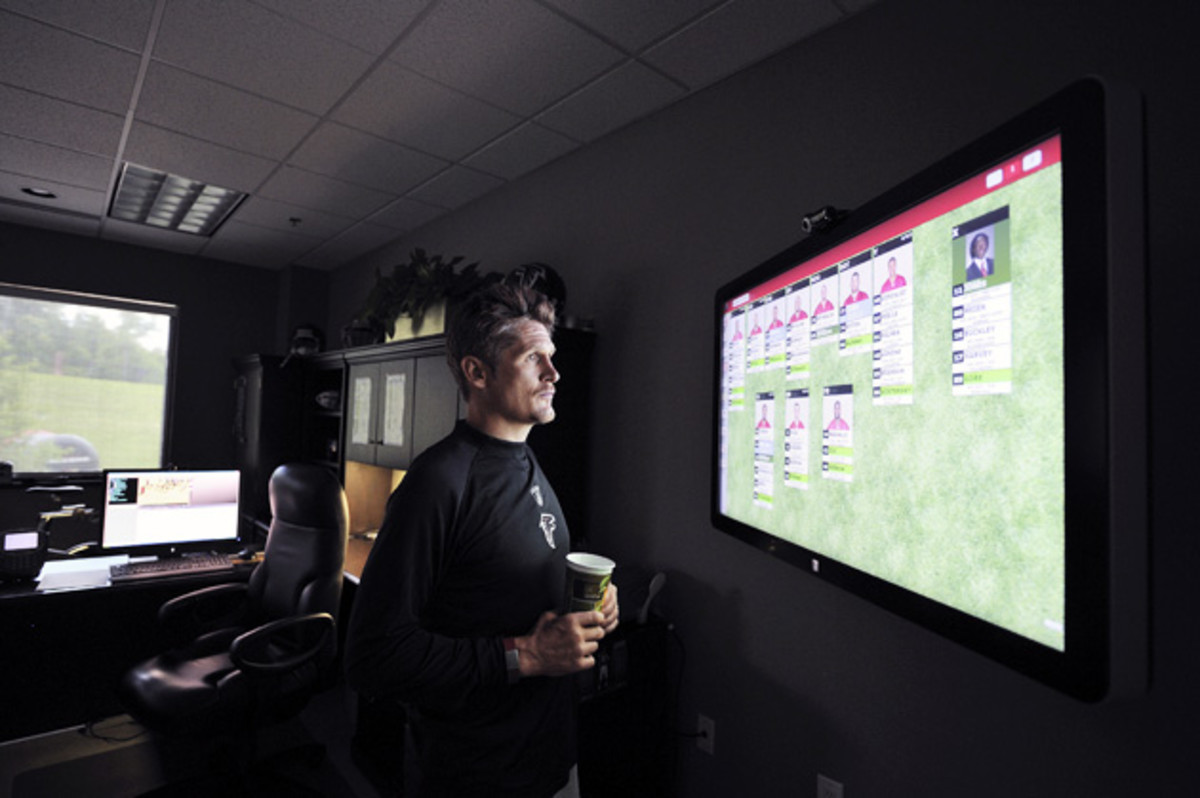 Dimitroff looks over the team's depth chart during training camp at Falcons' headquarters.