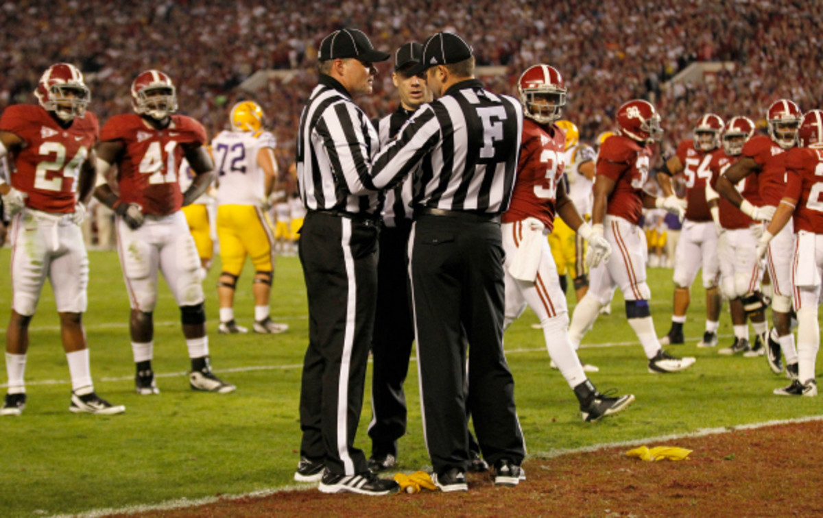 NCAA Schools currently use seven person officiating crews for football games. (Streeter Lecka/Getty Images)
