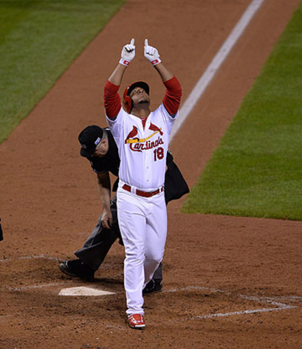 The image of Oscar Taveras pointing to the sky after his NLCS home run was prominent at his funeral eight days later. (David E. Klutho/Sports Illustrated)