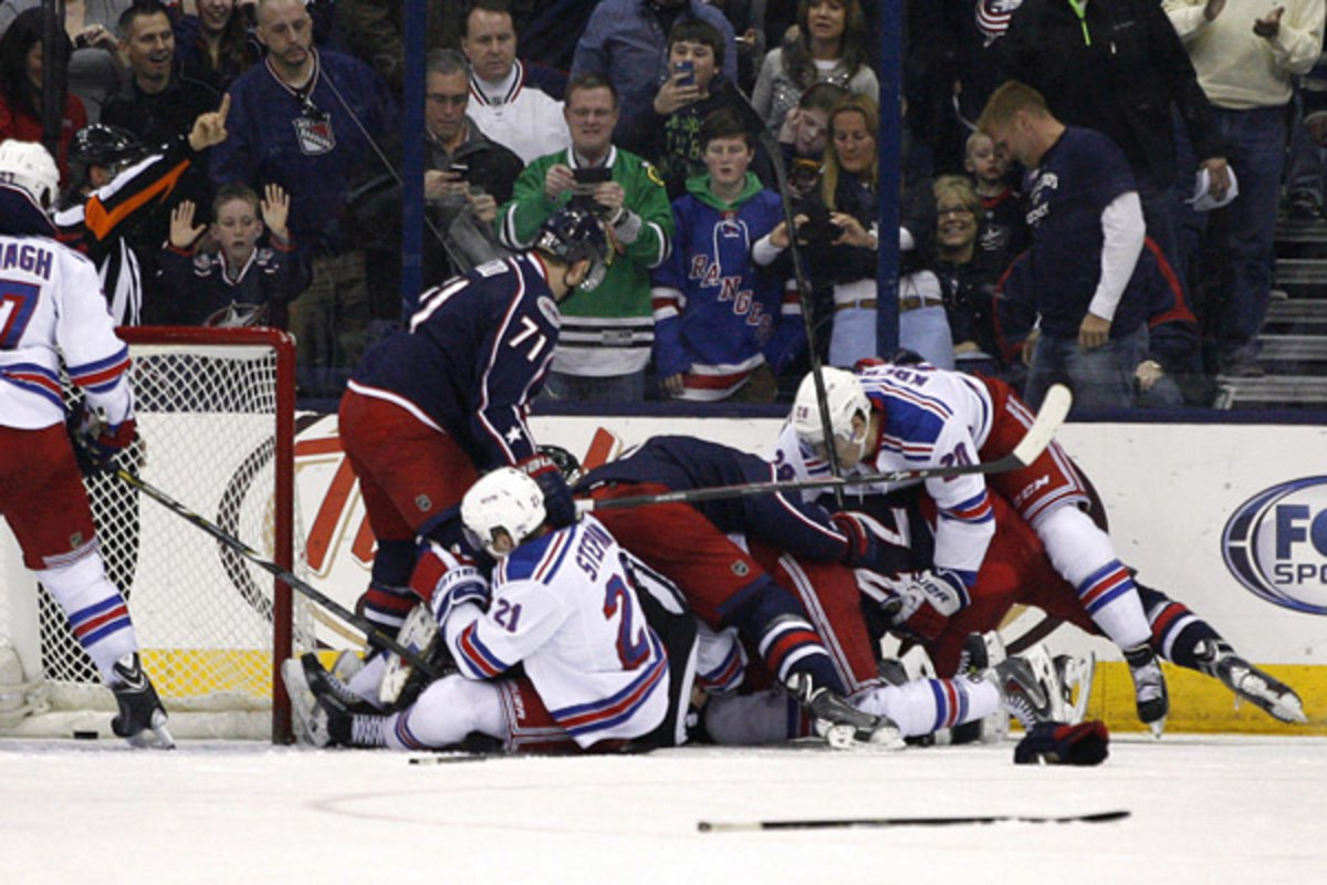 Rick Nash found himself at the bottom of this pile in a game that was as physical as it was emotional. (Mike Munden/AP)