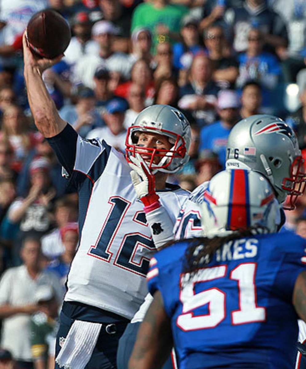 Tom Brady, who threw four TD passes Sunday, is now 23-2 in his career against the Bills. (Jim Davis/Getty Images)