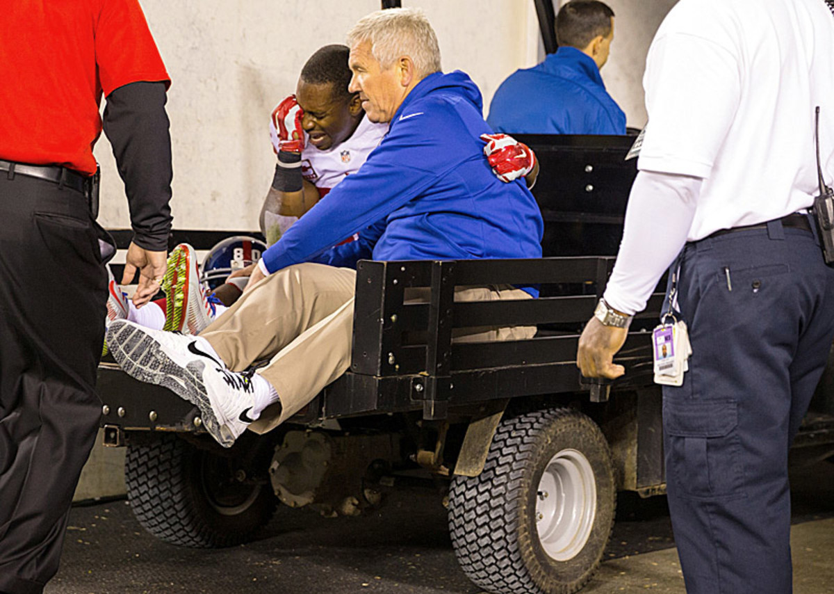 Cruz was overwhelmed by pain after a knee injury on Sunday night. (Al Tielemans/The MMQB/SI)