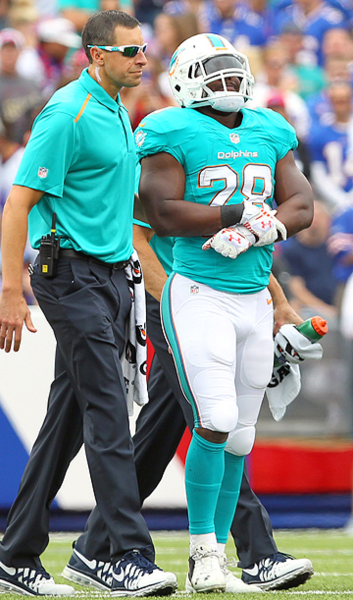 Knowshon Moreno, who suffered a dislocated elbow, was one of the many stars to go down on Sunday. (Bill Wippert/AP)
