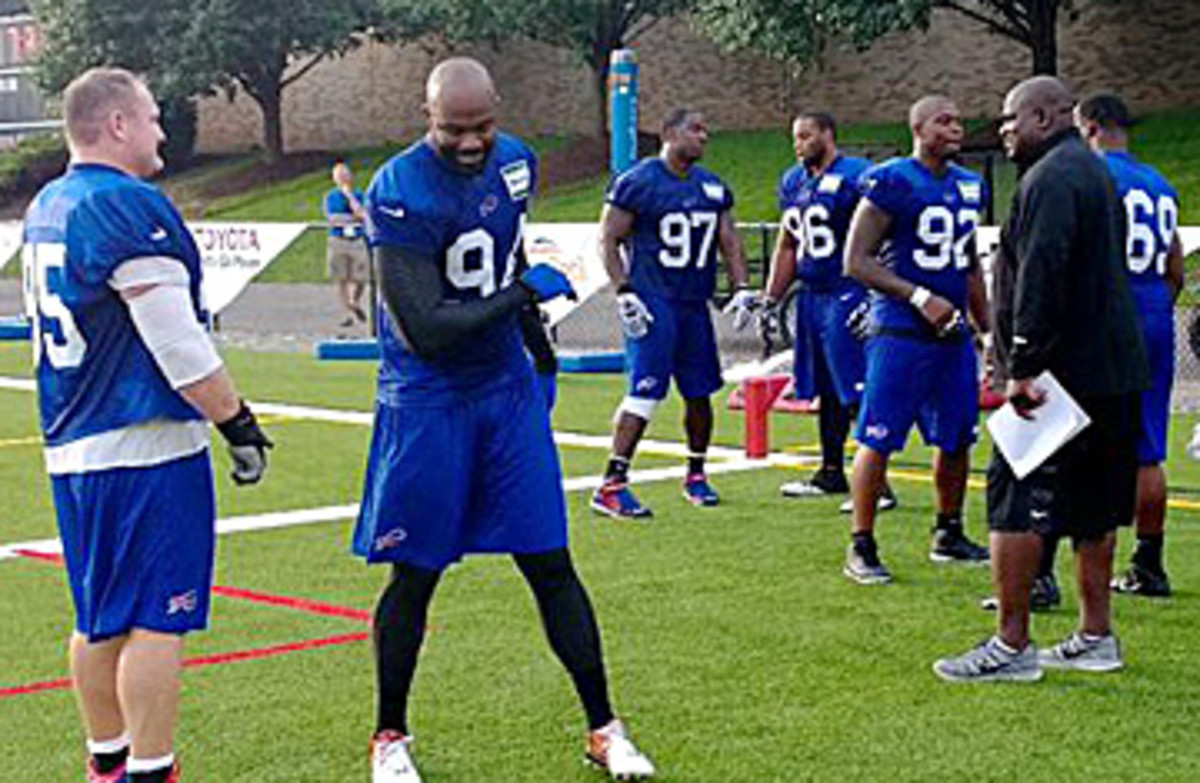 Pepper Johnson (right) will have plenty of talent to work with, including Kyle Williams (far left) and Mario Williams (center). (Peter King/The MMQB)