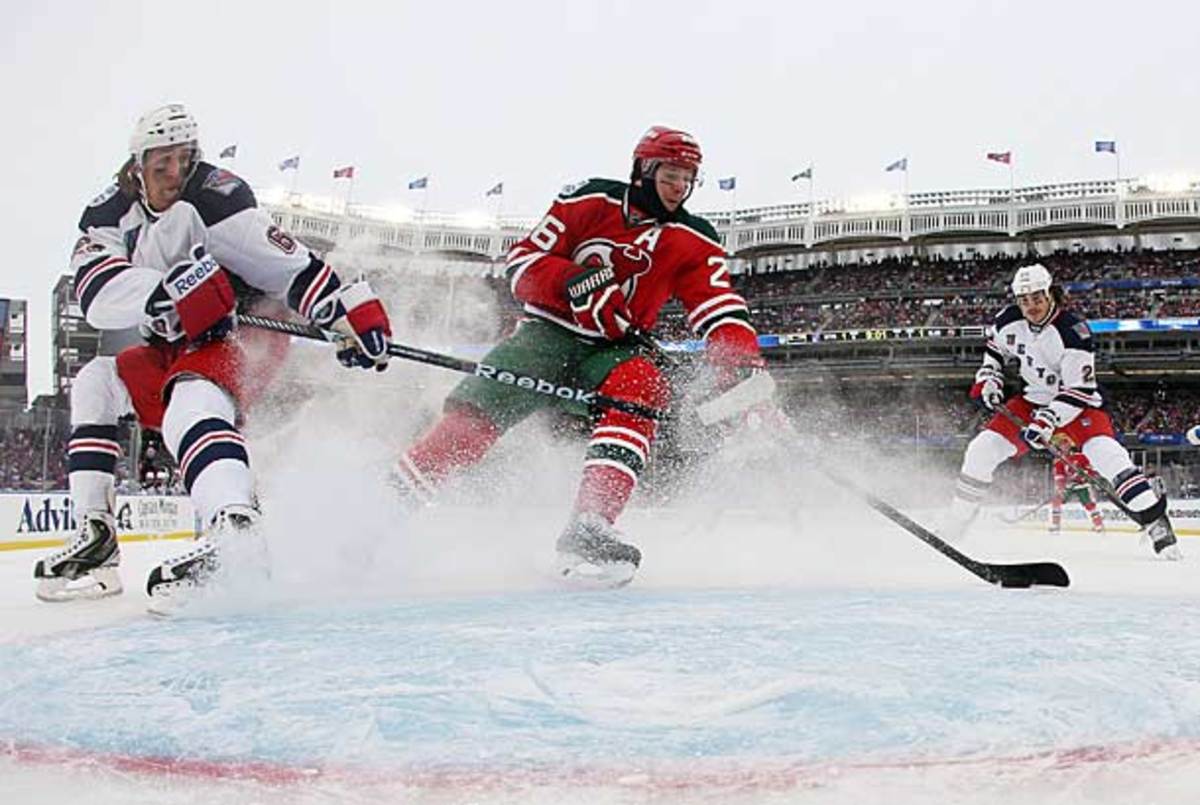 As temperatures and snow began to fall, the action the ice stayed hot with five first-period goals. (Bruce Bennett/Getty Images)