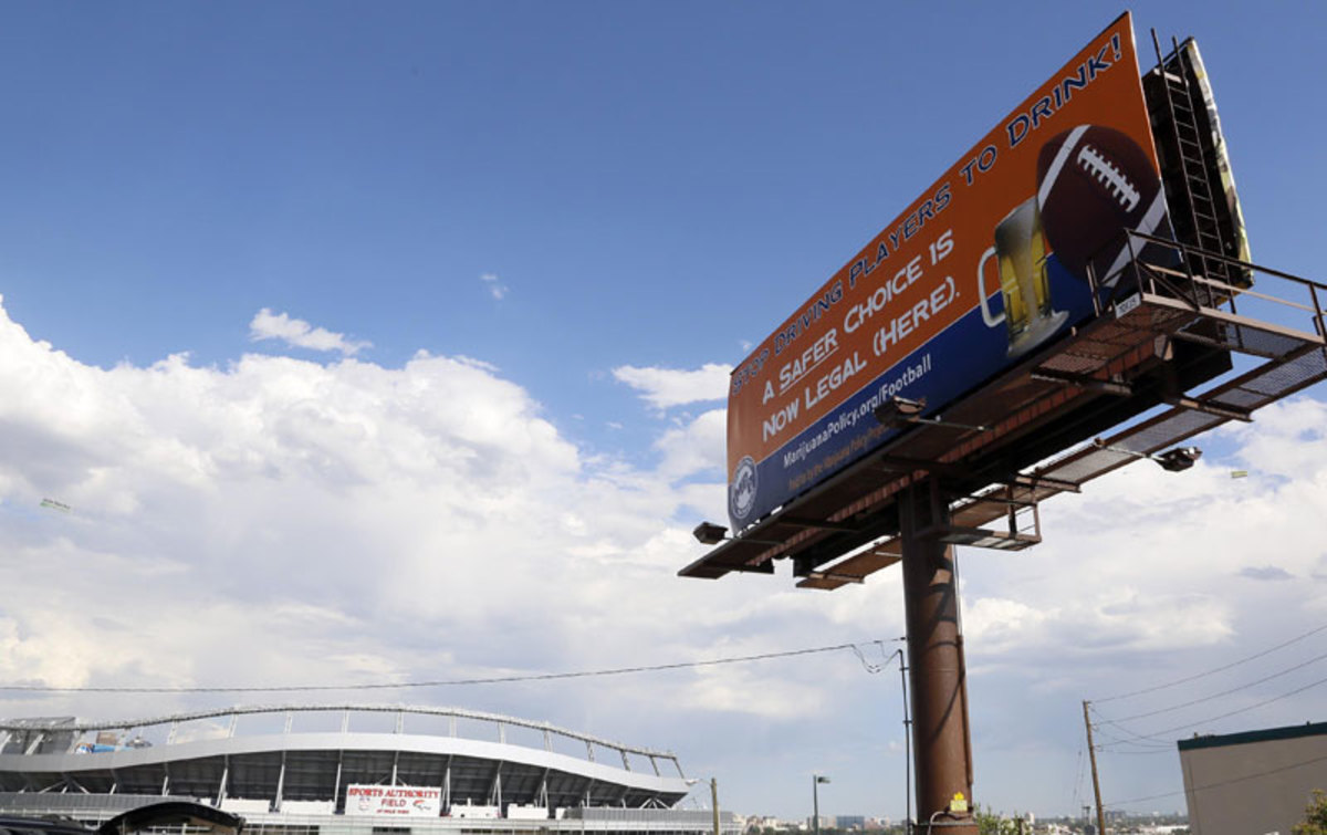 A sign near Sports Authority Field at Mile High before the season opener implied that marijuana was less problematic than alcohol—an argument echoed by NFL players. (Helen H. Richardson/The Denver Post via Getty Images)