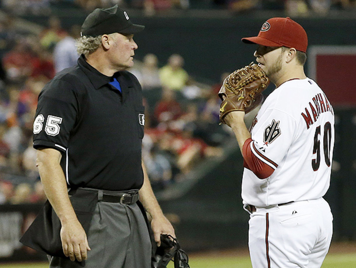 Arizona's Evan Marshall (right) was ejected for throwing at the Brewers' Ryan Braun. (Ross D. Franklin/AP)