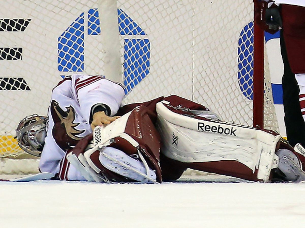 The Coyotes' Mike Smith had to be helped off the ice against the Rangers. (Bruce Bennett/Getty Images)