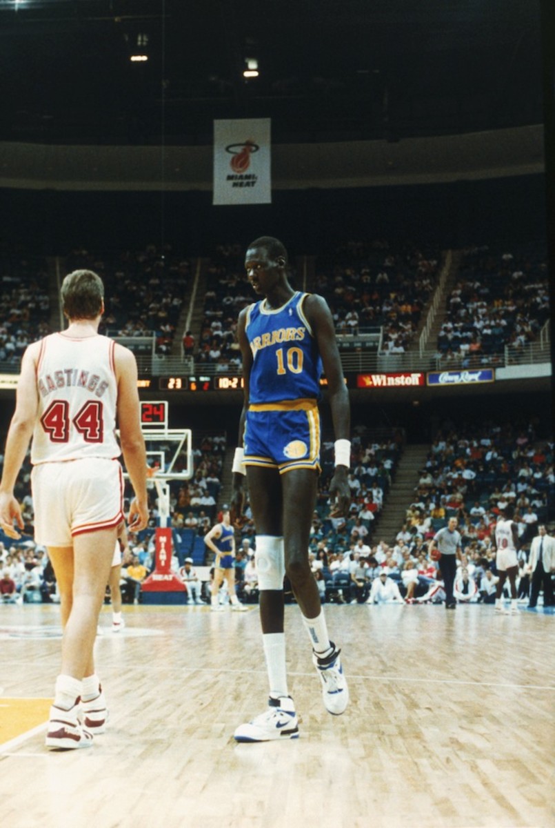 Manute Bol #10 of the Golden State Warriors looks on during a game against the Miami Heat in Miami, Florida.
