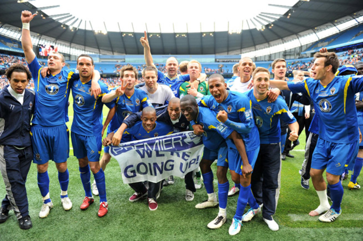 AFC Wimbledon celebrates gaining promotion to the Football League in 2011 after defeating Luton Town at City of Manchester Stadium.