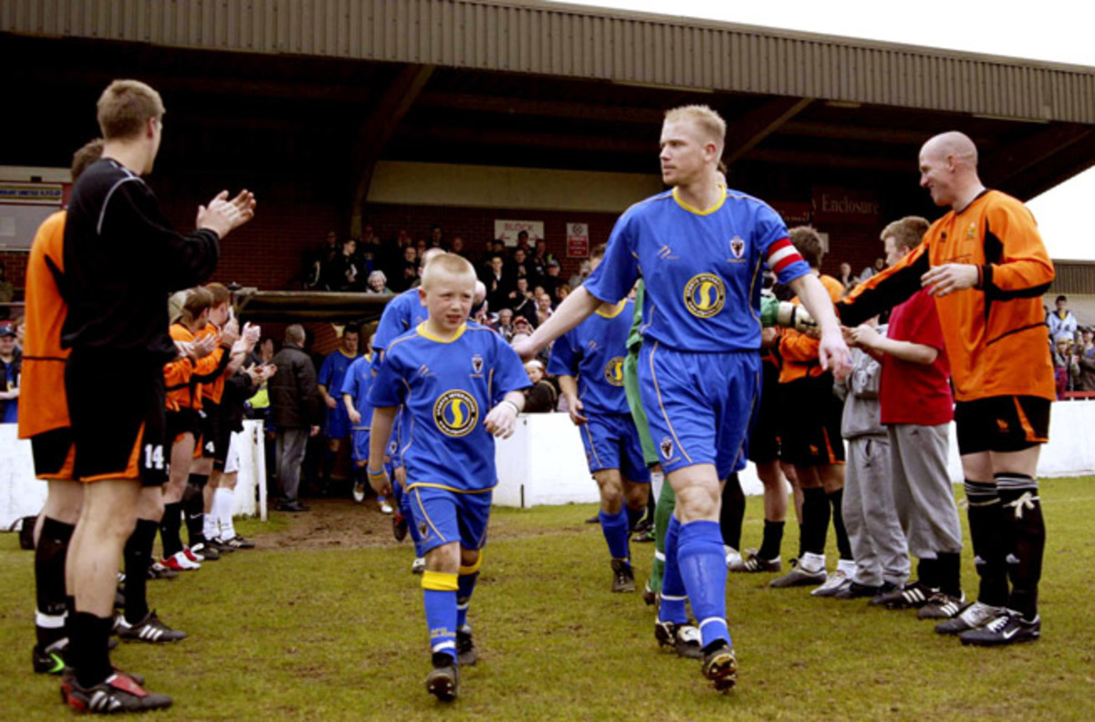 AFC Wimbledon captain Steve Butler leads the club through a champions guard of honor given by Division One opponent Cray in 2005.