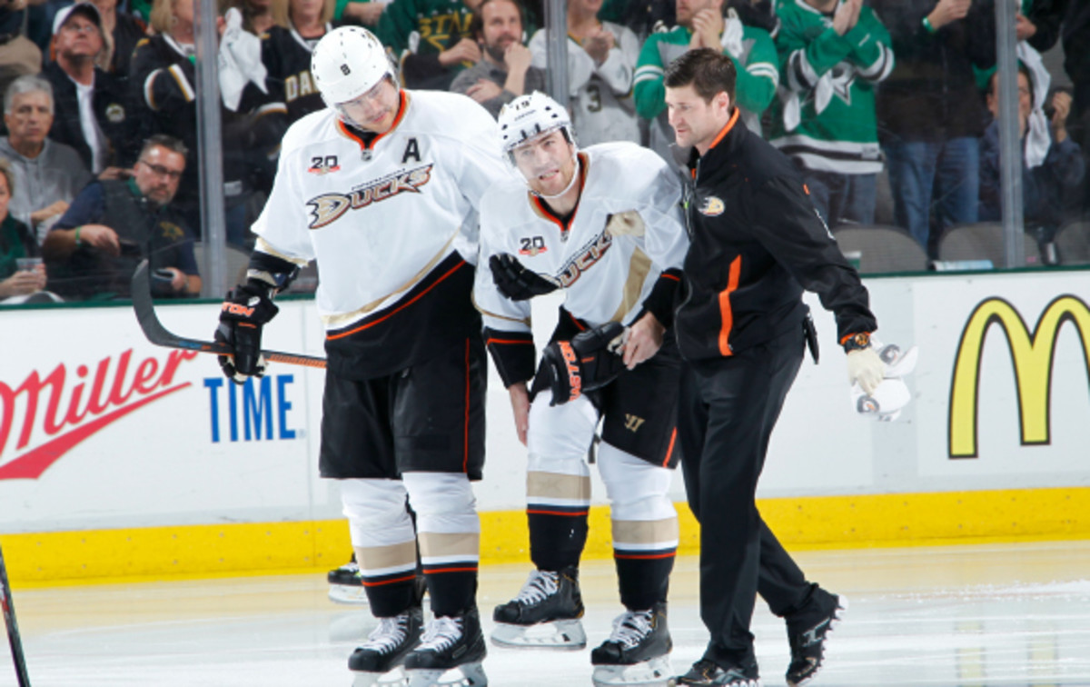 Stephane Robidas is helped off the ice after breaking his leg in his return to Dallas. (Glenn James/NHL/Getty Images)