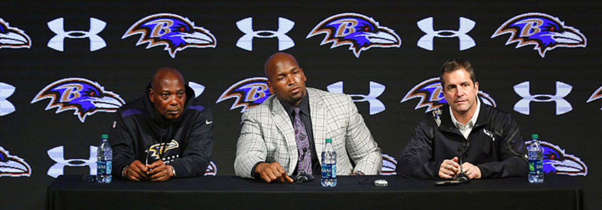     GM Ozzie Newsome (l.) and Ravens coach John Harbaugh bracket Ravens tackle Eugene Monroe as he talks about his new five-year contract on March 12. (Patrick Semansky/AP)