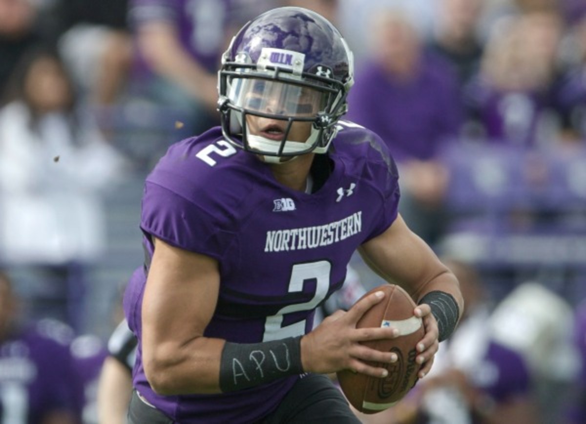 Northwestern quarterback Kain Colter wore "APU" wrist bands in quiet protest. (John Gress/Getty Images)