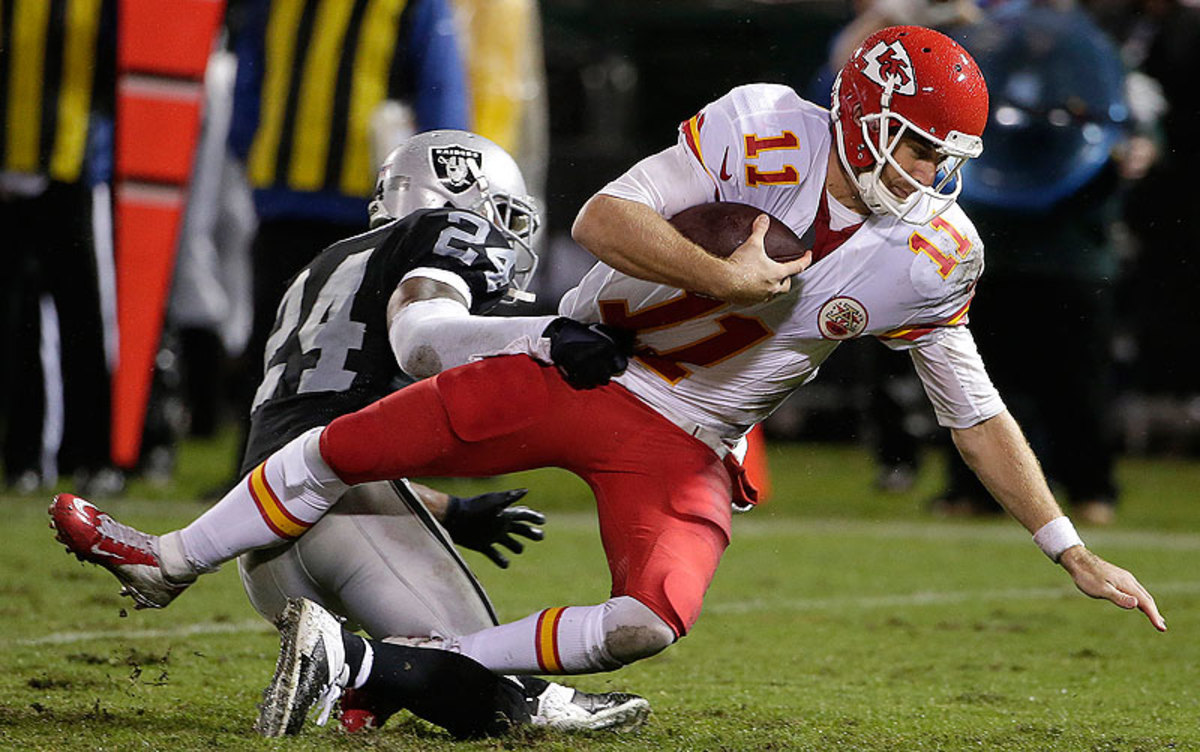 With this sack of Alex Smith, Charles Woodson became the first player in NFL history with 50 interceptions and 20 sacks in his career. (Marcio Jose Sanchez/AP)